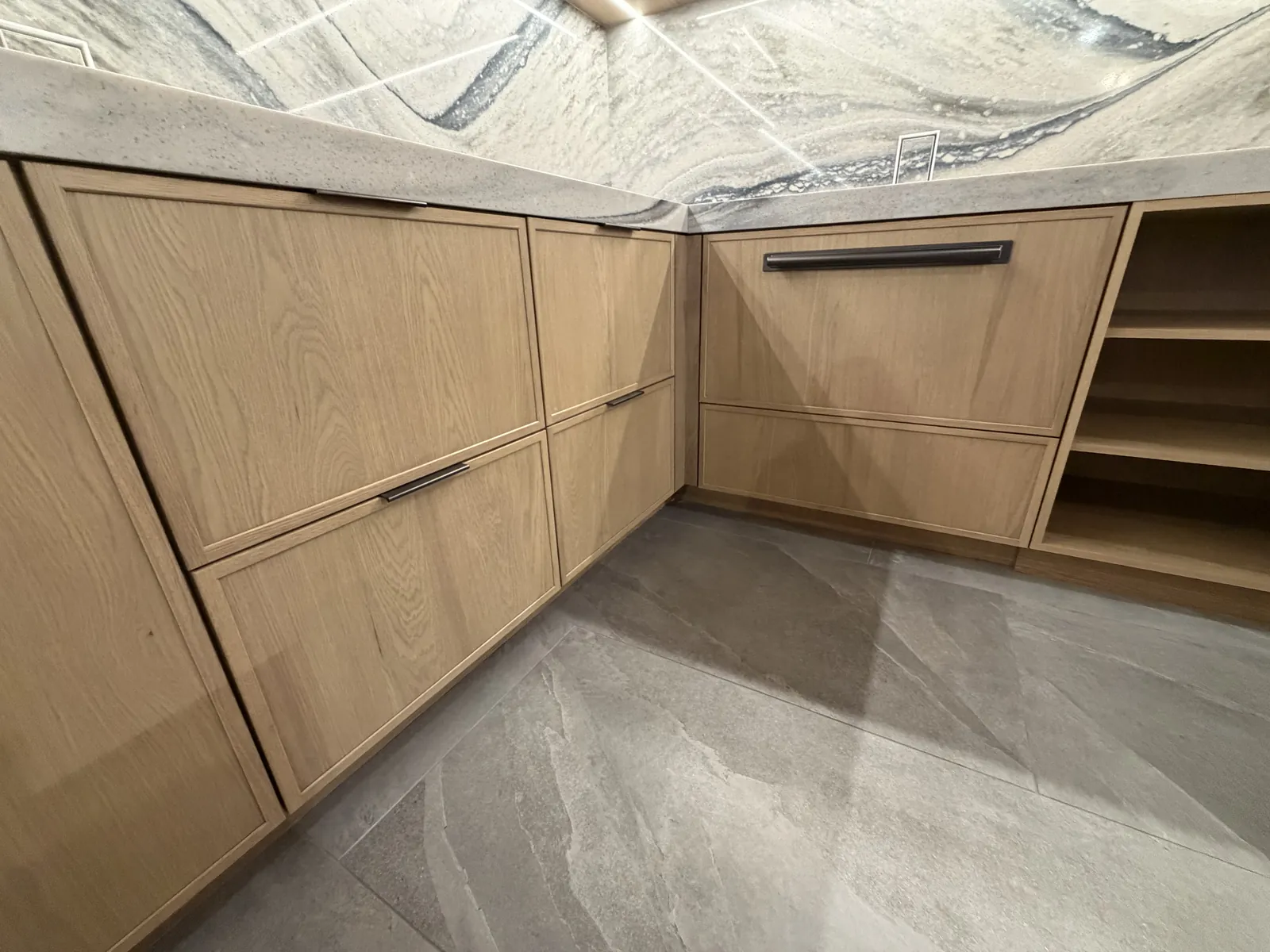 Flush Inset corner detail in White Oak Yosemite Brown — doors sit dead flush with the face frames, with pencil-thin reveals