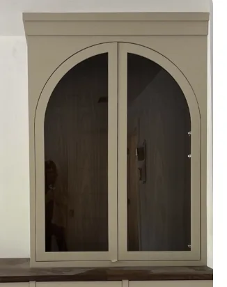 Painted display cabinet with a pair of tall glass doors whose tops form a full arch