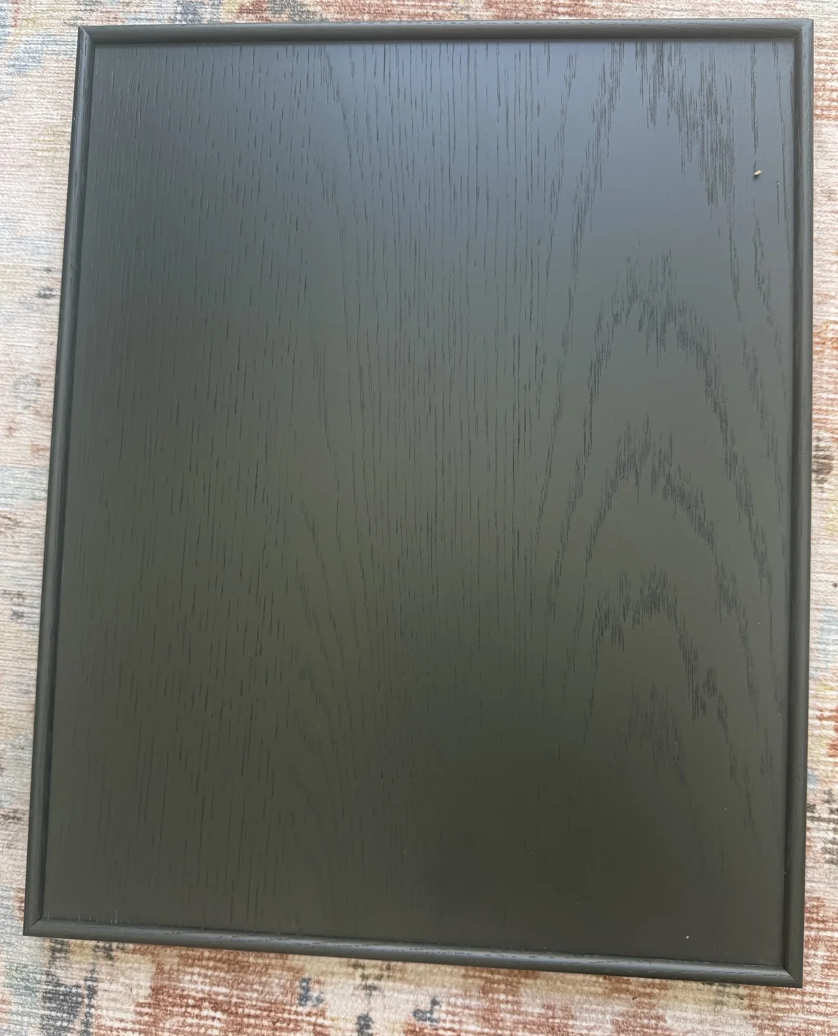 Pacifica flat panel door in Deep Water stain on White Oak, showing the slim rounded applied moulding framing a cathedral-grain oak panel