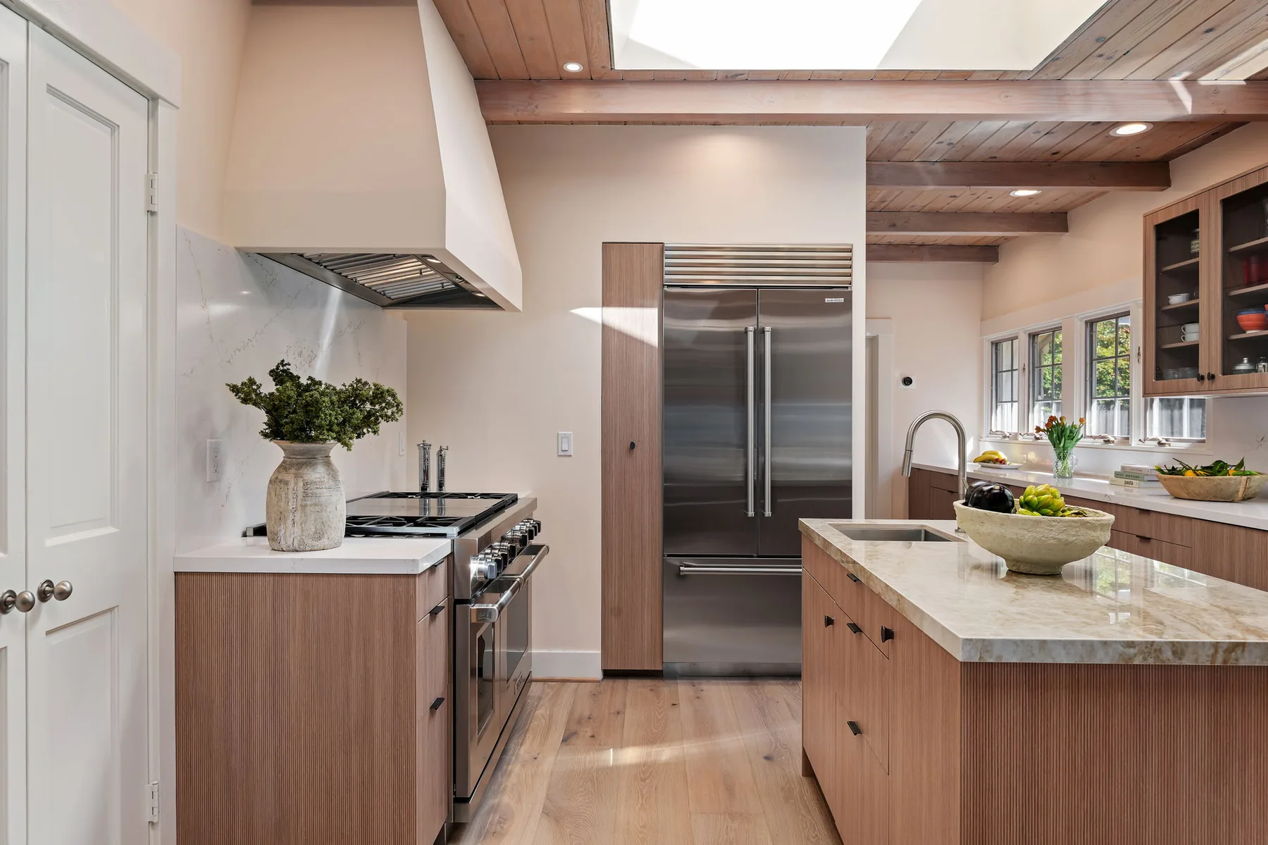 Range wall with paneled Sub-Zero column and secondary island