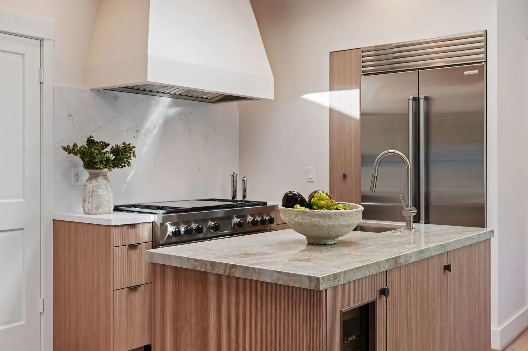 Close view of the Linear oak reeded texture on the island and range cabinetry