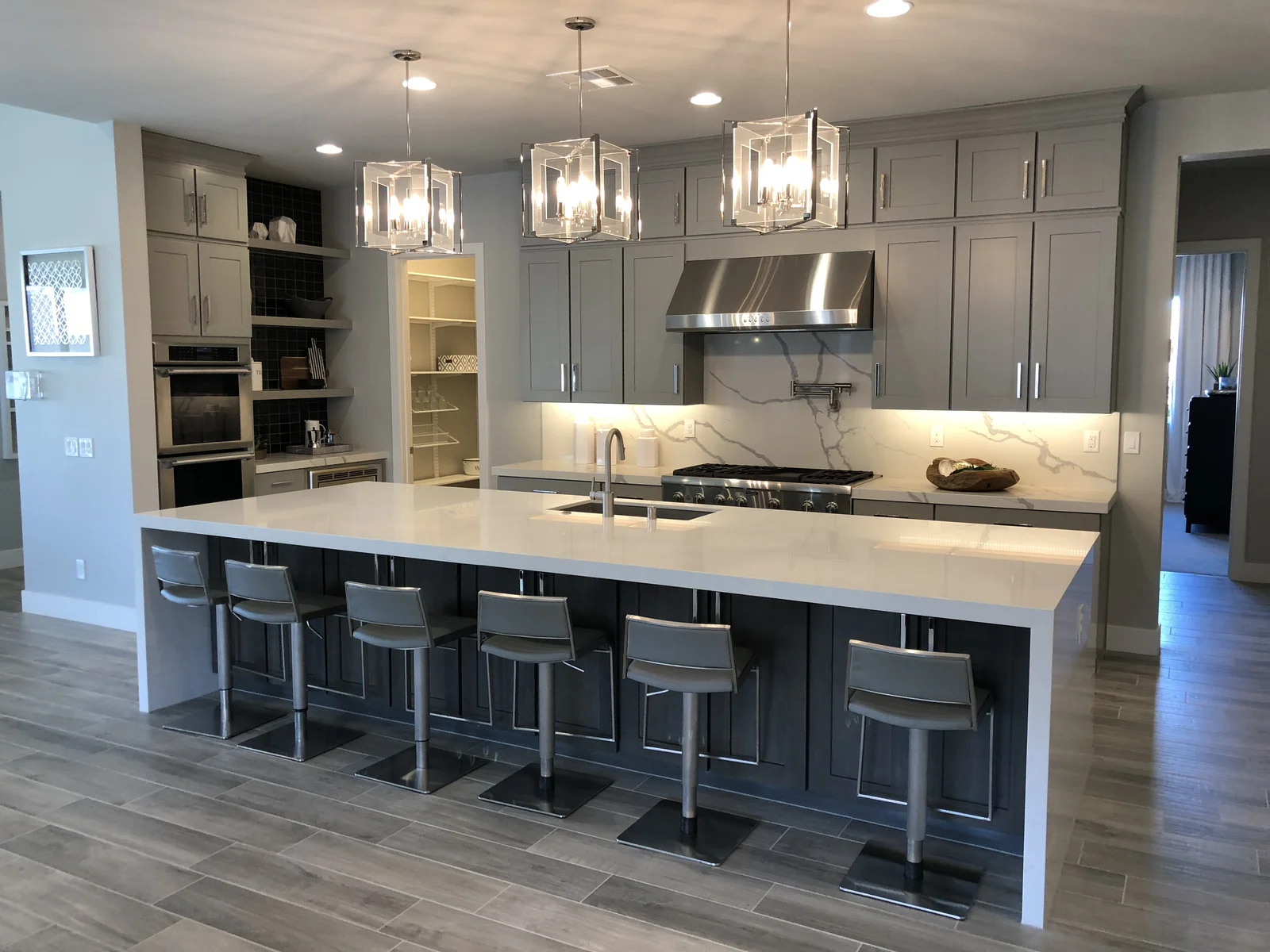 Aspect Cabinetry kitchen with gray shaker cabinets and quartz island