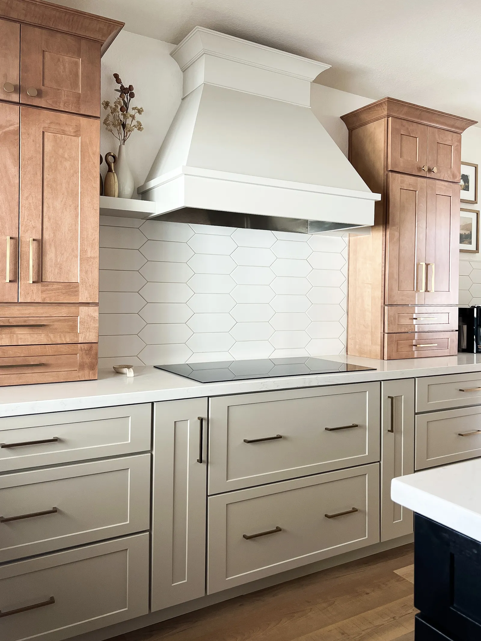 Builders Floor and Designs kitchen — cooktop and hood close-up