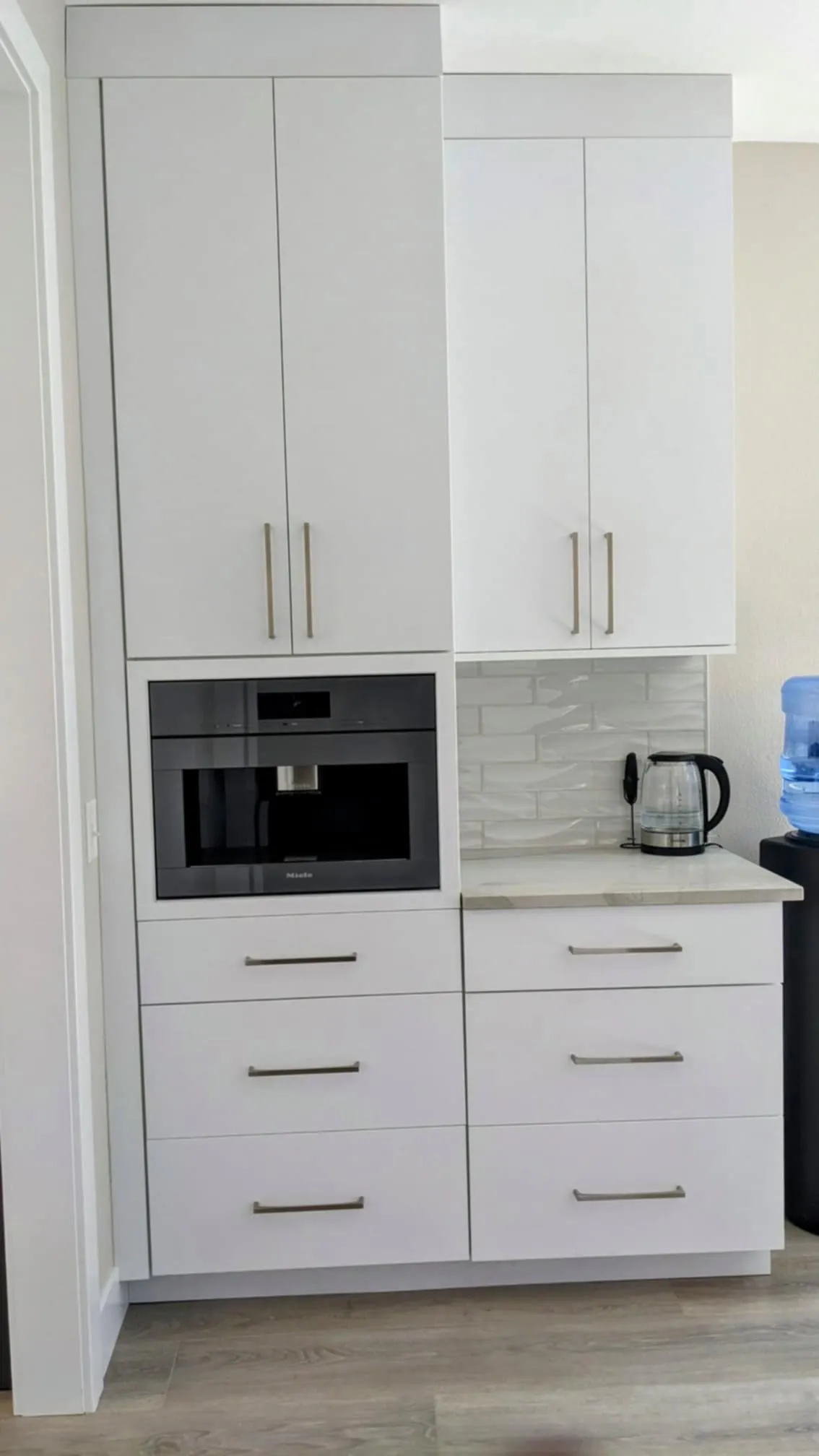 Greenwood Cabinetry kitchen — flush-installed Miele coffee station
