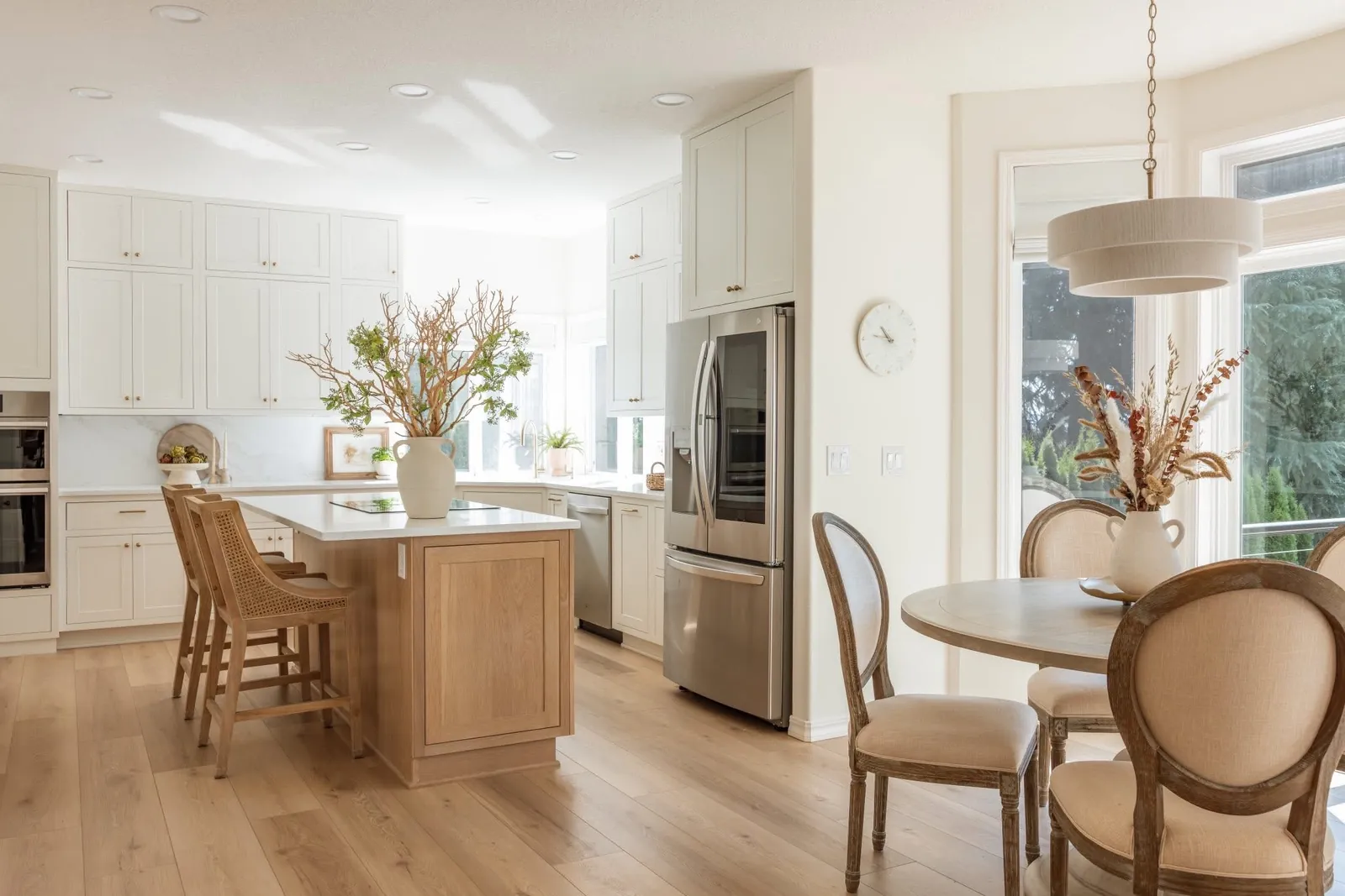 Stutler Cabinets Hanover kitchen — Soft White Hanover door close-up with marble back, artichokes in a pedestal bowl, taper candles